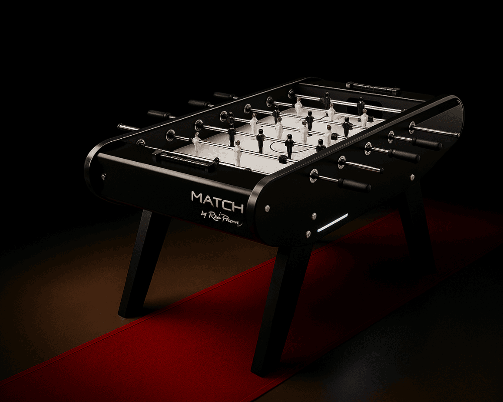 Black René Pierre MATCH foosball table with black and white players, shown on a red carpet