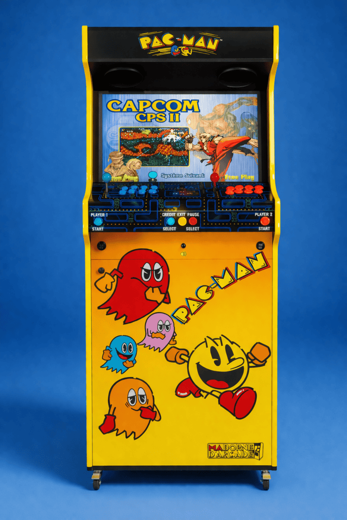 Yellow Pac-Man arcade cabinet with two-player controls and a fighting-game selection screen