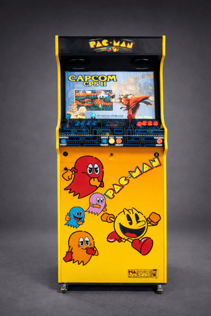 Yellow arcade cabinet decorated with Pac-Man characters, with a game selection screen and controls for two players