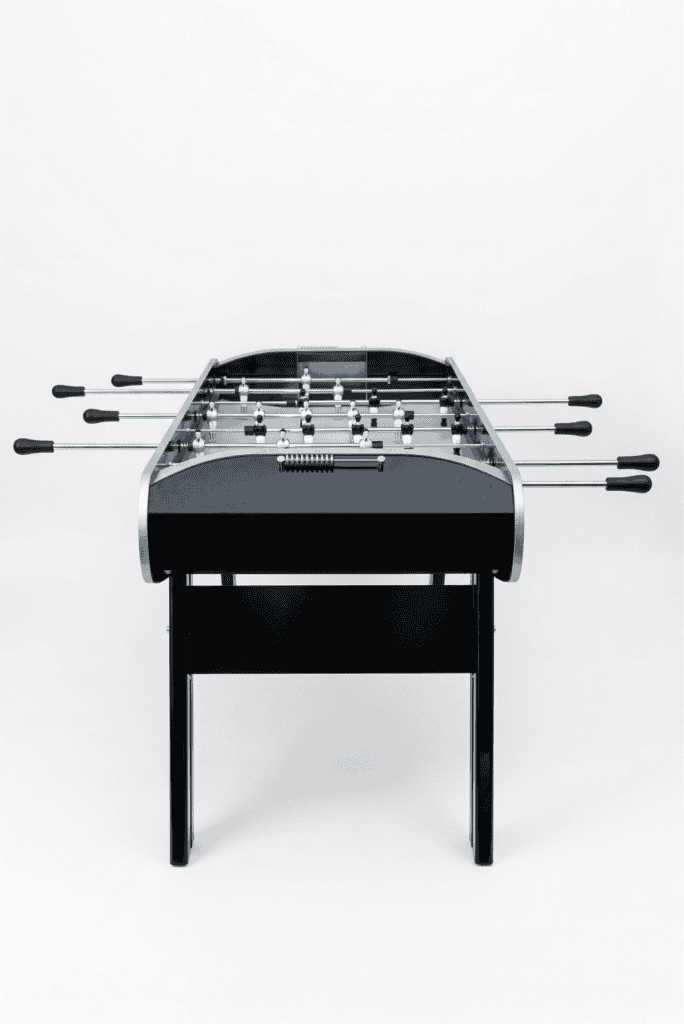 Black professional foosball table with chrome rods, front view on a white background